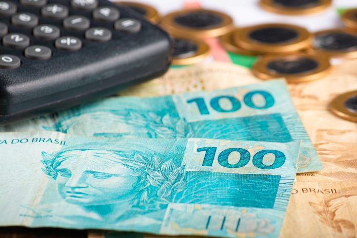 Finance concept. One hundred reais banknotes with calculator and