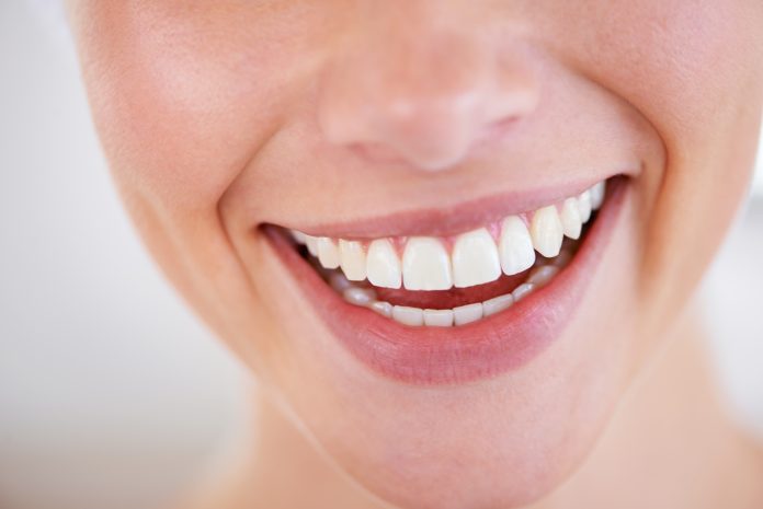 Smile a while. Close up of a womans sparkling teeth